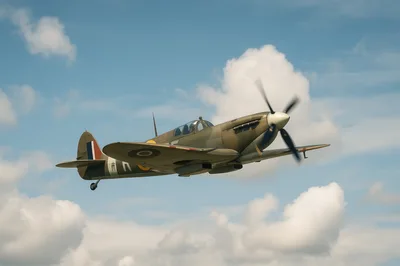 Vintage Supermarine Spitfire Fighter Plane Flying In Sky
