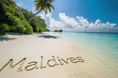 Maldives Written In The Sand On A Tropical Beach