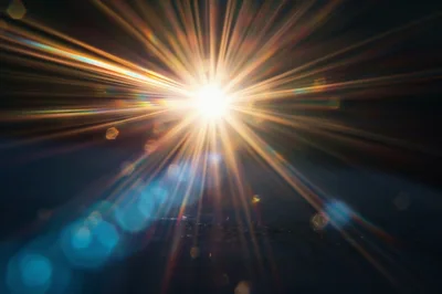 Bright Starburst Lens Flare Effect On Dark Background