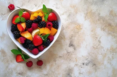 Heart Shaped Bowl Filled With Fresh Fruit Salad