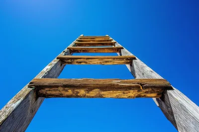 Low Angle View Of A Wooden Ladder Against Blue Sky