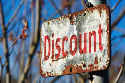Weathered Metal Discount Sign Outdoors
