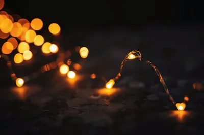 Glowing Fairy Lights On Dark Textured Surface