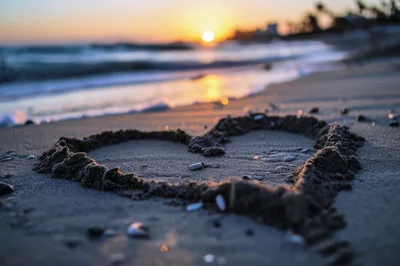 Heart Shape Drawn In Sand On Beach At Sunset