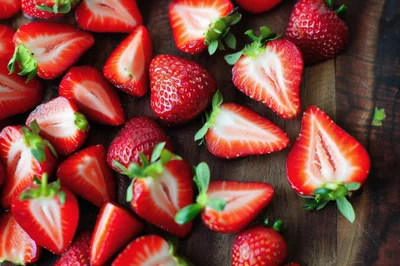Fresh Sliced Strawberries On A Wooden Cutting Board
