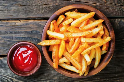 Bowl of Golden French Fries with Ketchup