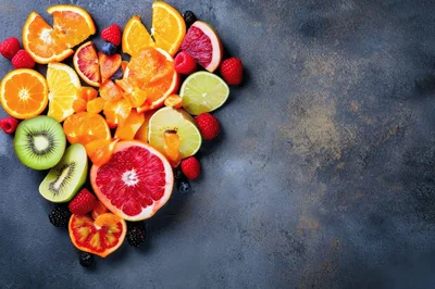Assorted Fresh Citrus Fruits and Berries on Dark Background