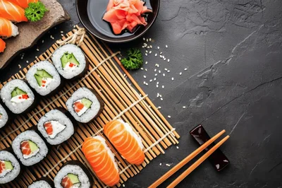 Top View Of Sushi Rolls And Nigiri On Bamboo Mat