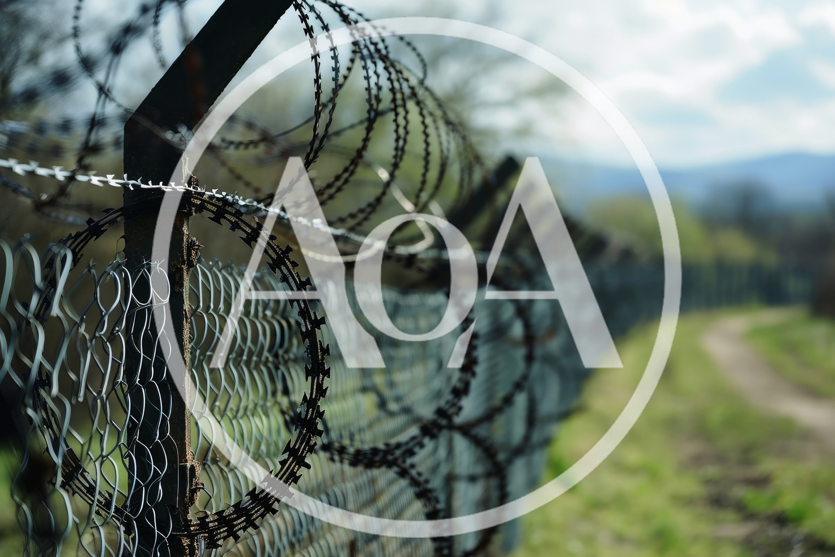 Razor Wire Fence Along A Rural Path