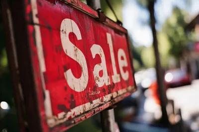 Weathered Red Sale Sign Hanging Outdoors
