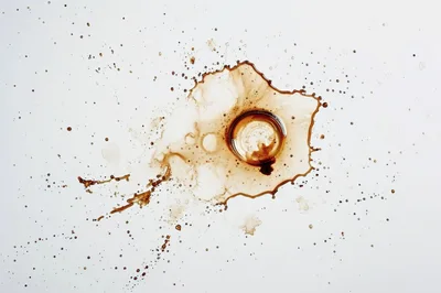 Coffee Spill With Circular Stain On White Surface