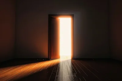 Open Doorway With Bright Light In Dark Room