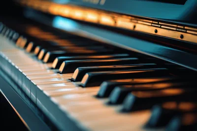 Close Up Of Grand Piano Keys In Warm Lighting