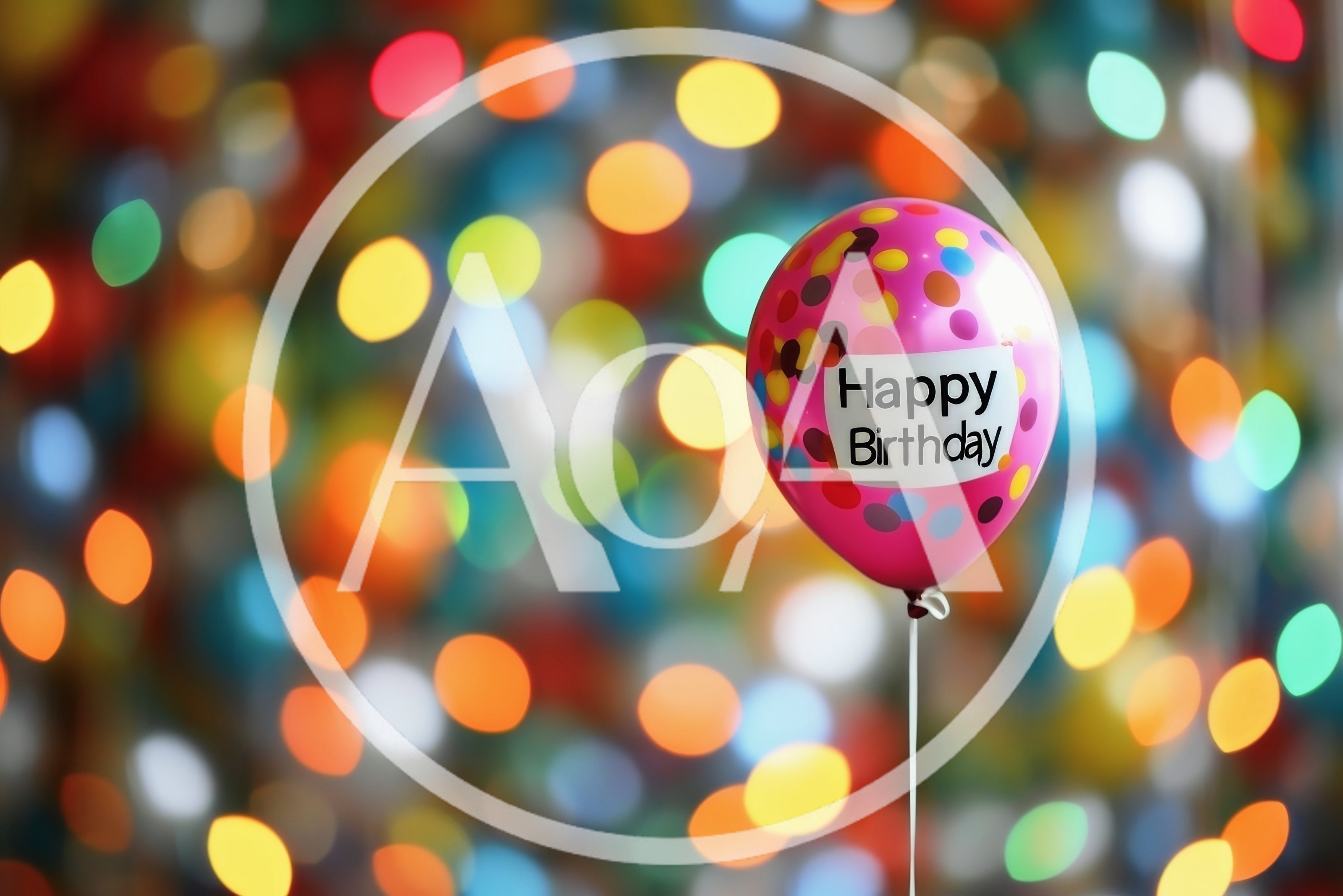 Pink Happy Birthday Balloon Against Colorful Bokeh Lights