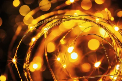 Glowing Golden Fairy Lights In Dark Background