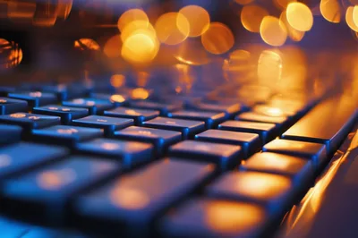 Close Up Of Computer Keyboard With Bokeh Lighting