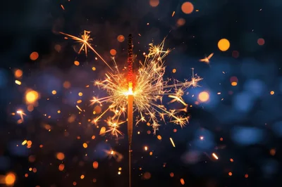 Burning Sparkler Emitting Bright Golden Sparks
