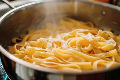 Steaming Fresh Fettuccine Pasta In A Stainless Steel Pan