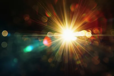 Abstract Golden Light Burst With Bokeh Background