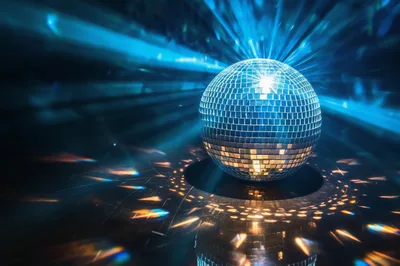 Shiny Disco Ball Reflecting Blue Light In Dark Club