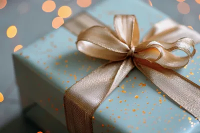 Blue Gift Box With Gold Ribbon And Bokeh Lights