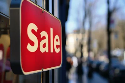 Red Sale Sign Hanging In A Store Window