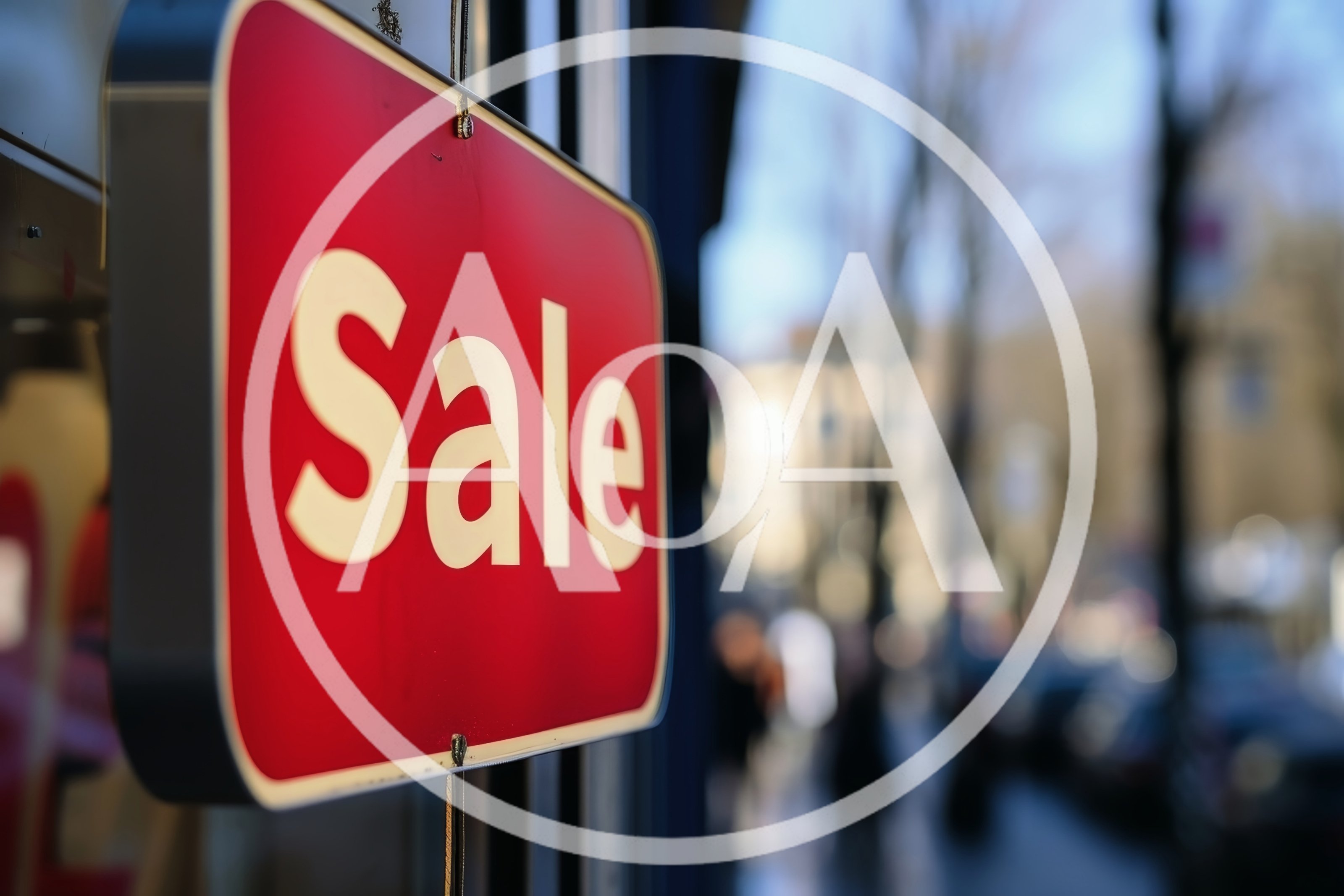 Red Sale Sign Hanging In A Store Window