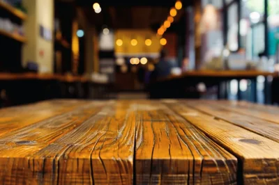 Rustic Wooden Table Surface in Blurred Cafe Interior