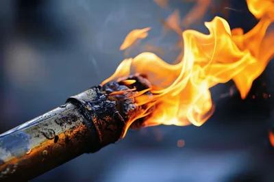 Burning Metal Torch With Bright Orange Flames