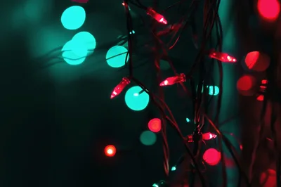 Red Christmas String Lights Against Teal Bokeh Background