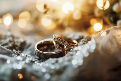 Elegant Wedding Rings Resting On Lace Fabric