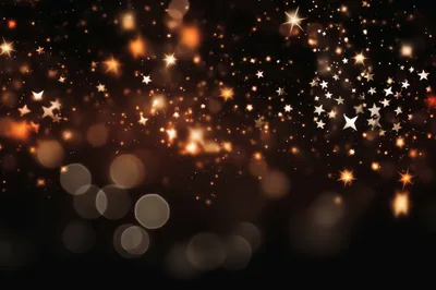 Golden Star Particles Floating on Dark Background