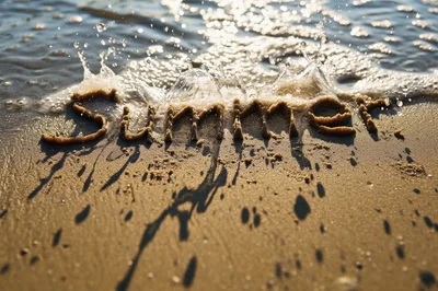 Summer Word Written In Sand With Incoming Wave