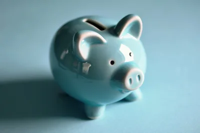 Light Blue Ceramic Piggy Bank On Solid Background