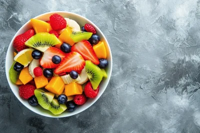 Fresh Fruit Salad Bowl on Concrete Background