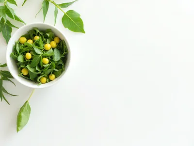 Bowl of Fresh Green Leaves and Yellow Berries