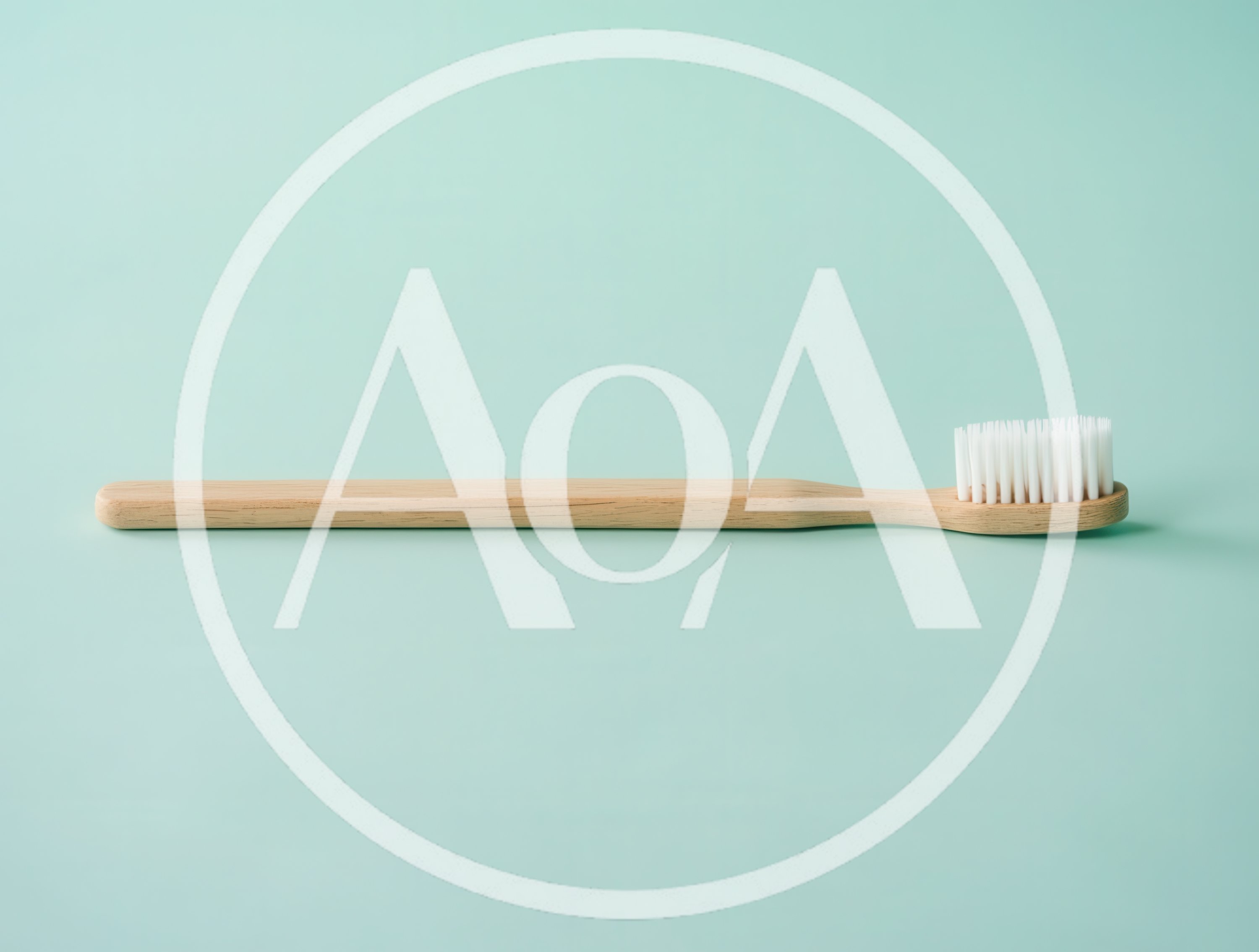 Wooden Toothbrush On A Pastel Green Background
