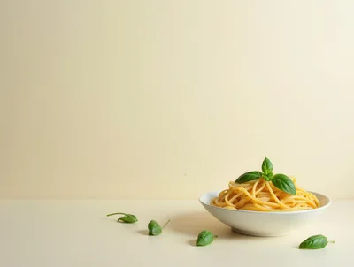 Bowl of Spaghetti Pasta with Fresh Basil Leaves
