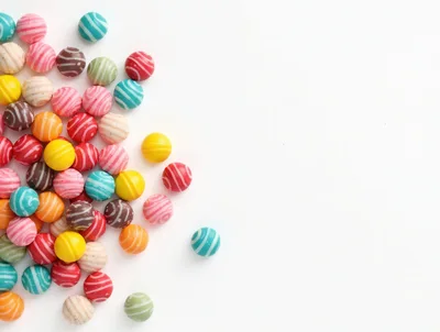 Colorful Striped Gumball Candies on White Background