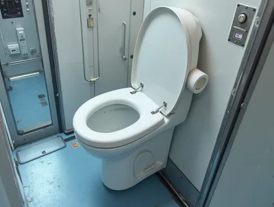 Modern White Toilet Inside A Train Restroom