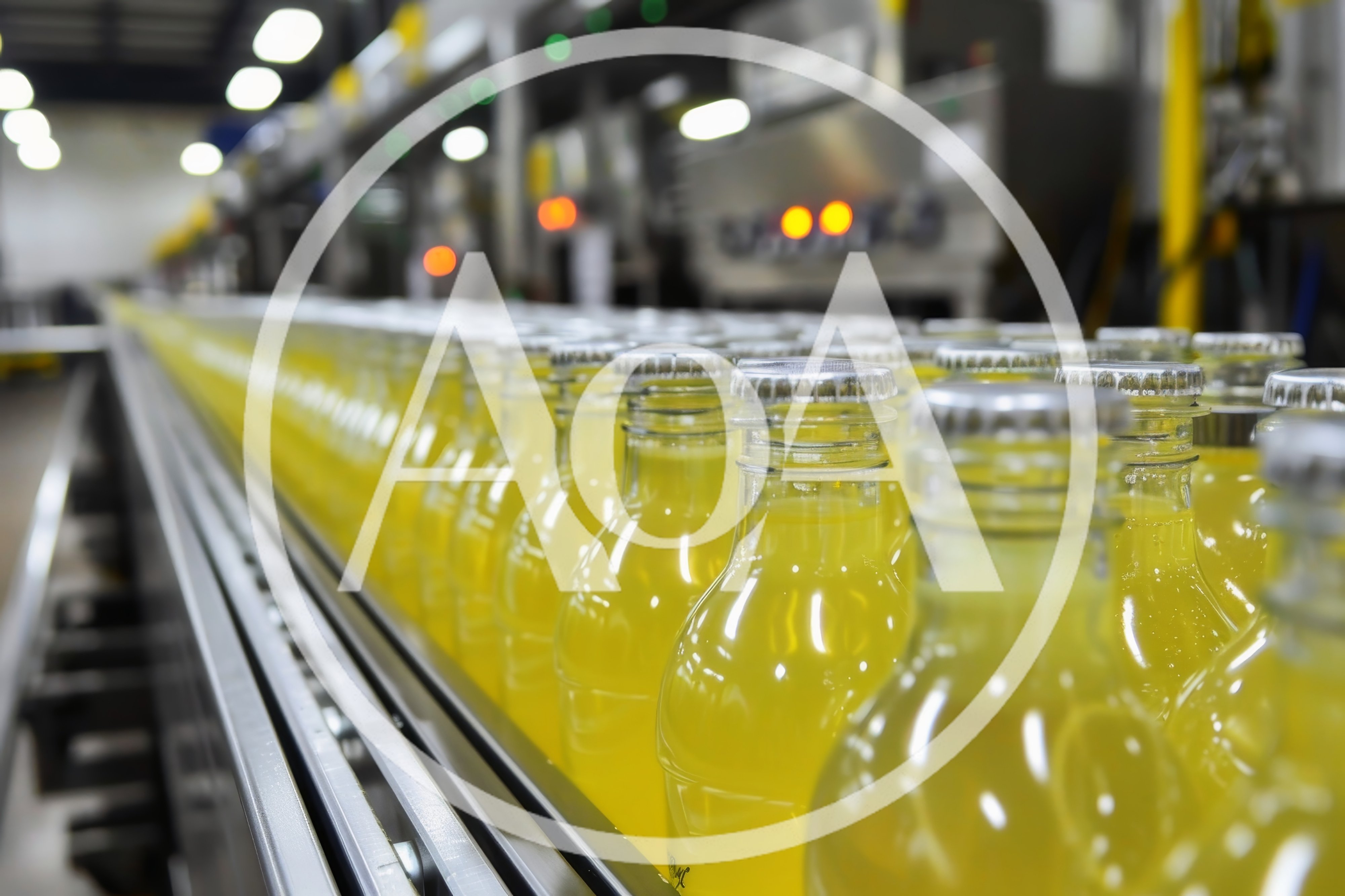 Yellow Soda Bottles Moving Along Industrial Conveyor Belt