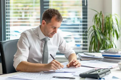 Professional Businessman Working With Financial Documents In Office