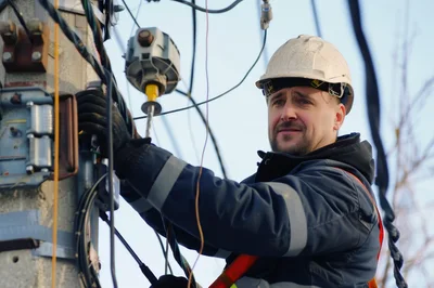 Electrician Working On Utility Pole Maintenance