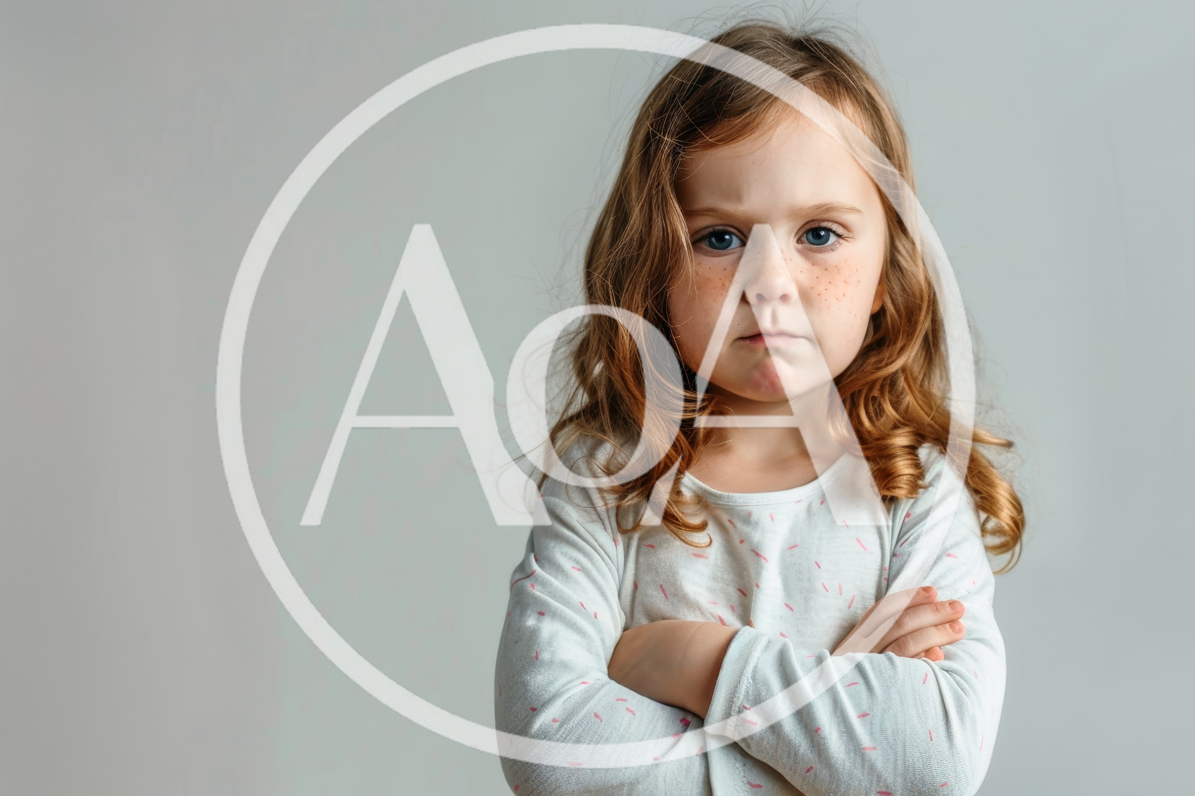 Portrait of a Grumpy Little Girl With Crossed Arms