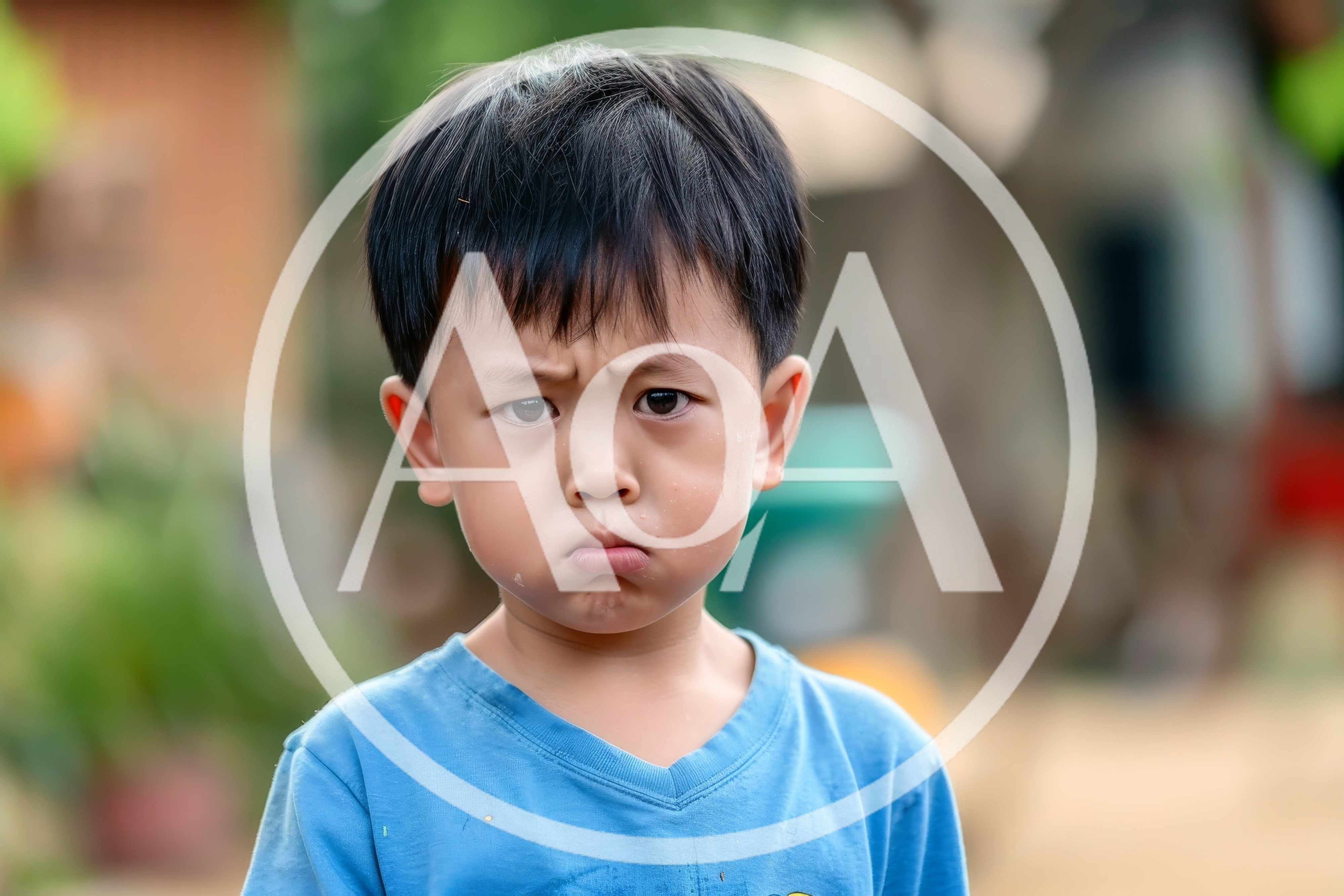Portrait of a Grumpy Young Asian Boy
