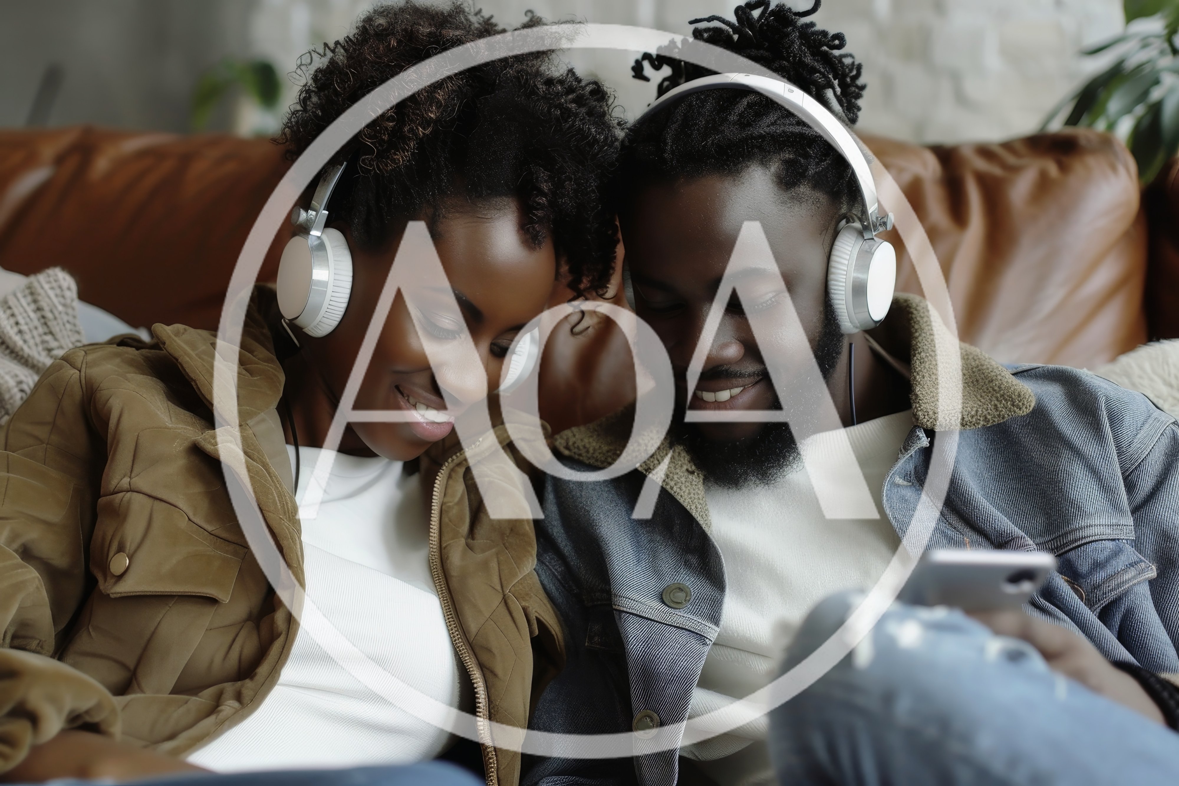 Young Black Couple Listening To Music Together On Sofa
