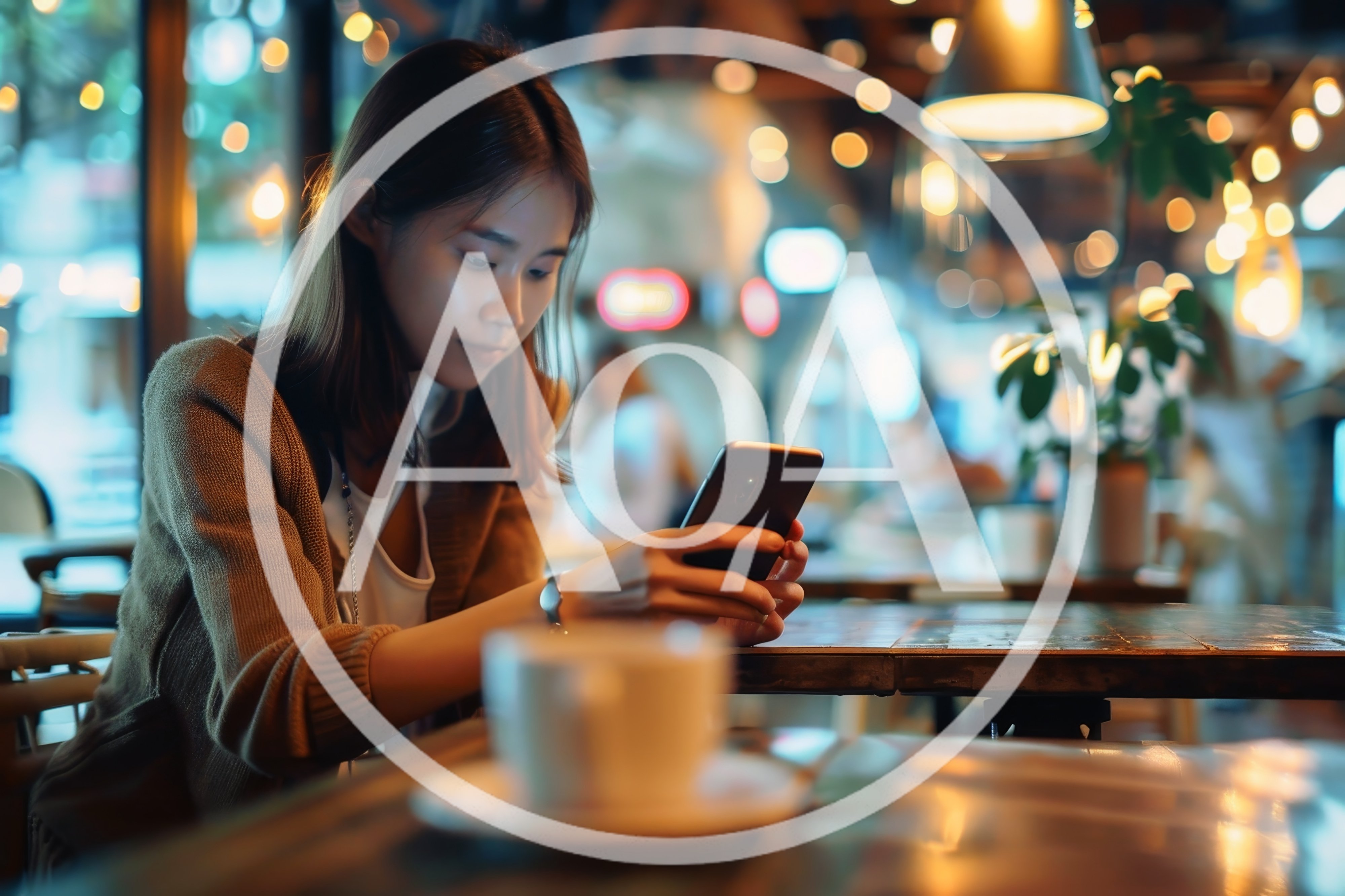 Young Woman Using Smartphone In A Cozy Cafe