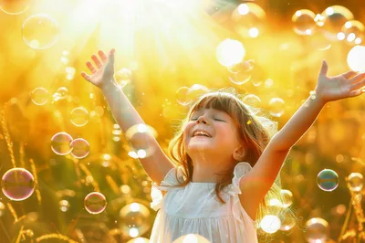 Happy Little Girl Playing With Bubbles Outdoors