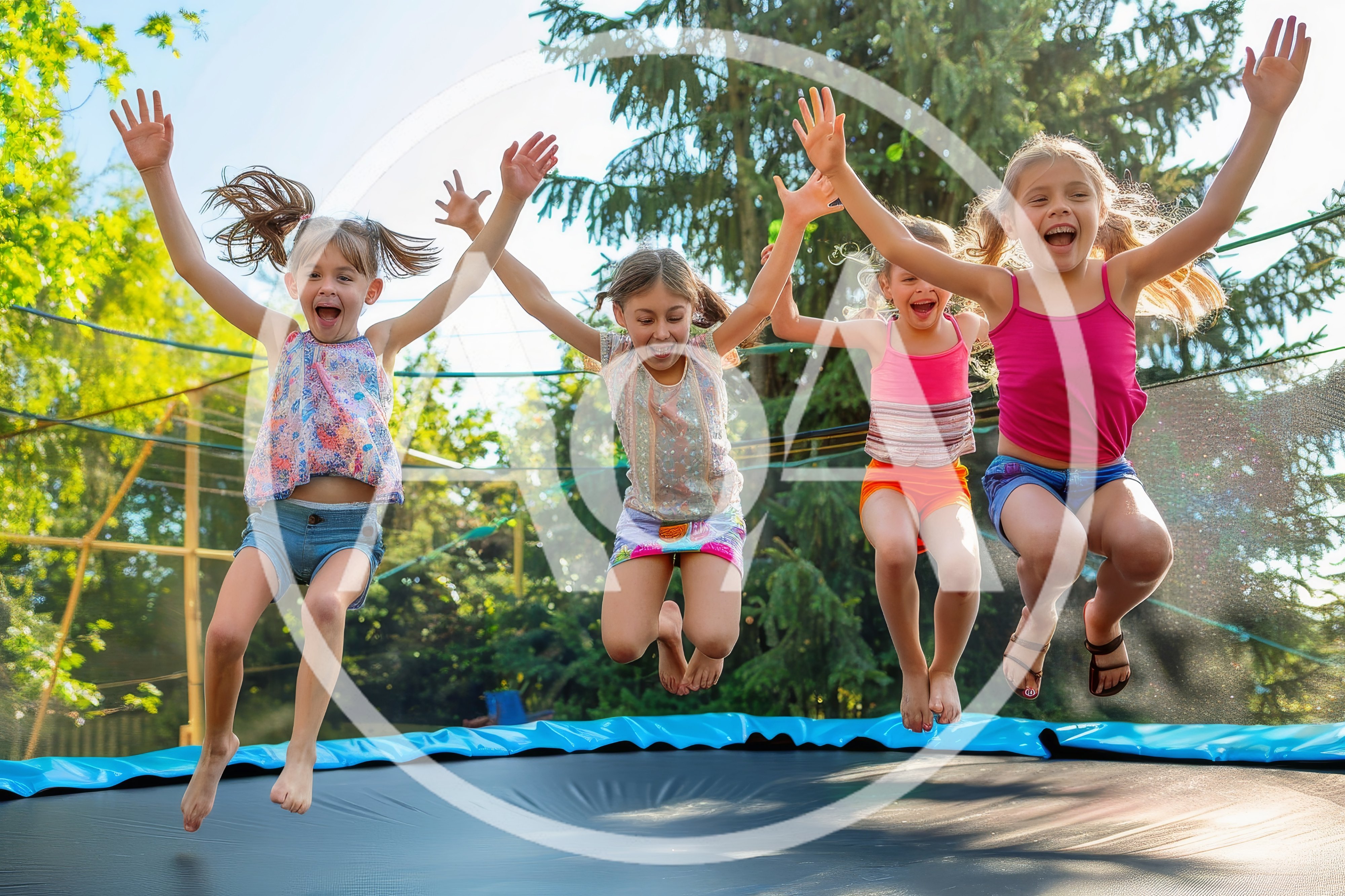 Four Happy Young Girls Jumping Together On A Trampoline