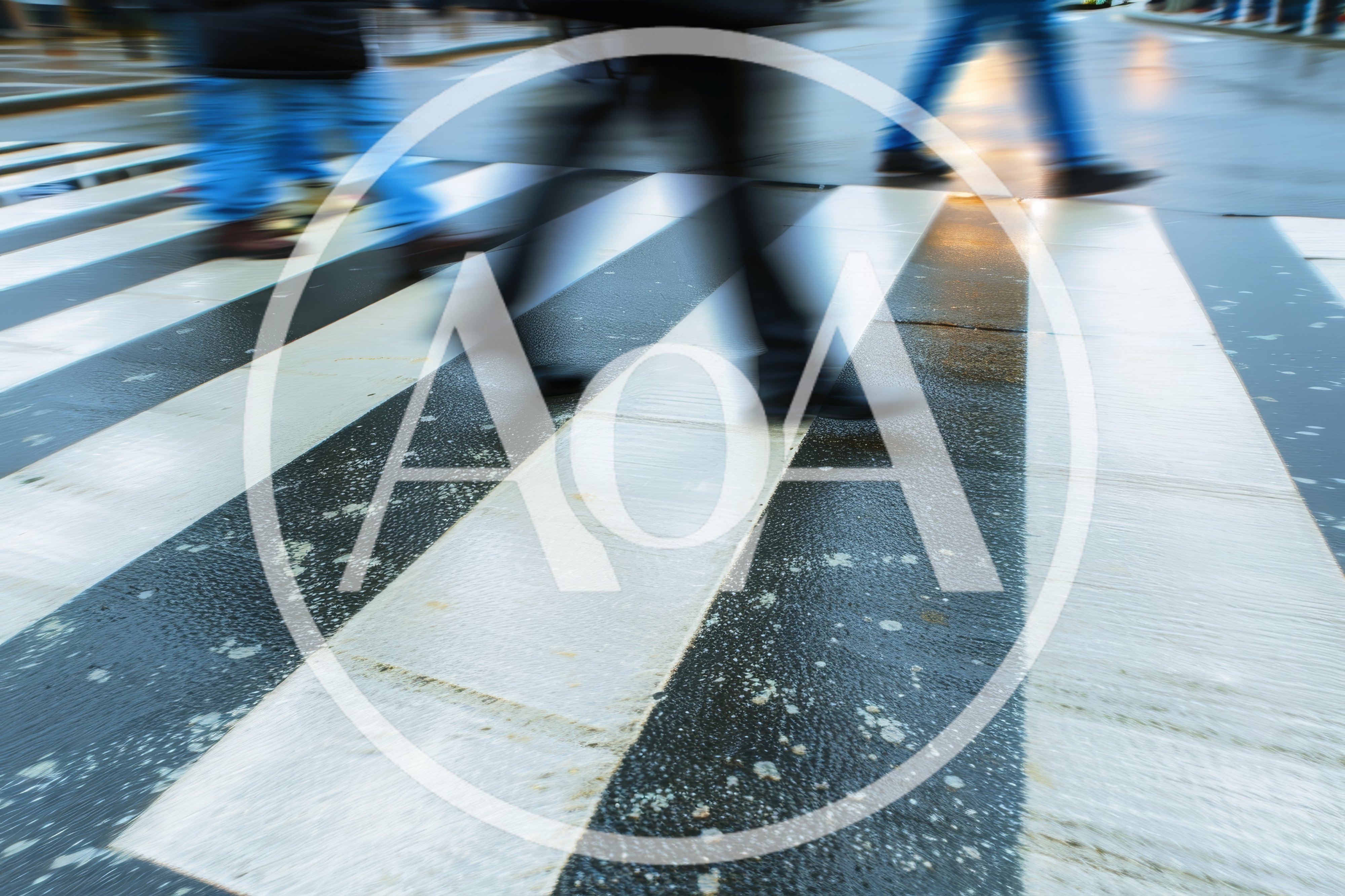 Motion Blur Pedestrians Crossing A Wet Zebra Crossing
